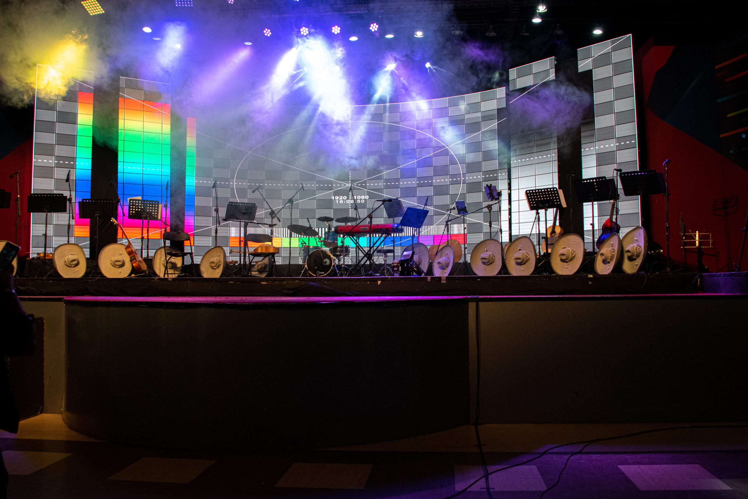 Stage set with instruments lit in blue ahead of a live band performance